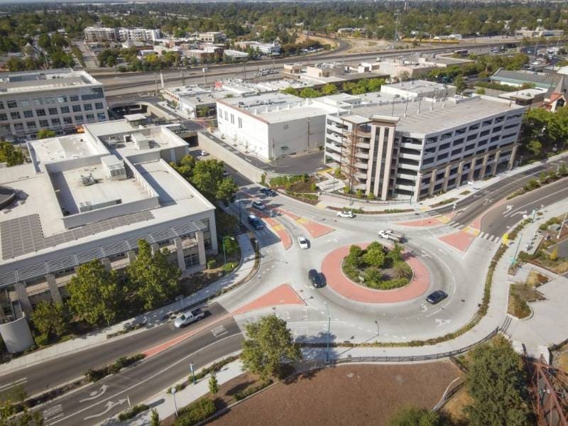Aerial view of commercial buildings and roadways in Roseville, CA, illustrating land surveying for urban development. 